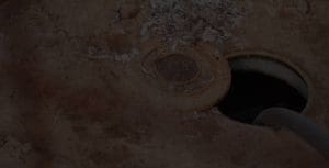 septic system cleaning - tank with lid off and pump working