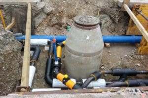septic system installation with access and exposed pipes prior to burying the system