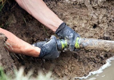 a person is repairing the septic system pipe