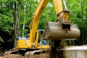 an excavator is excavating as part of a septic service