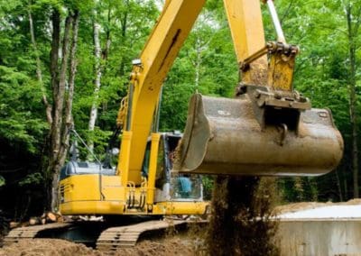 an excavator is excavating the road