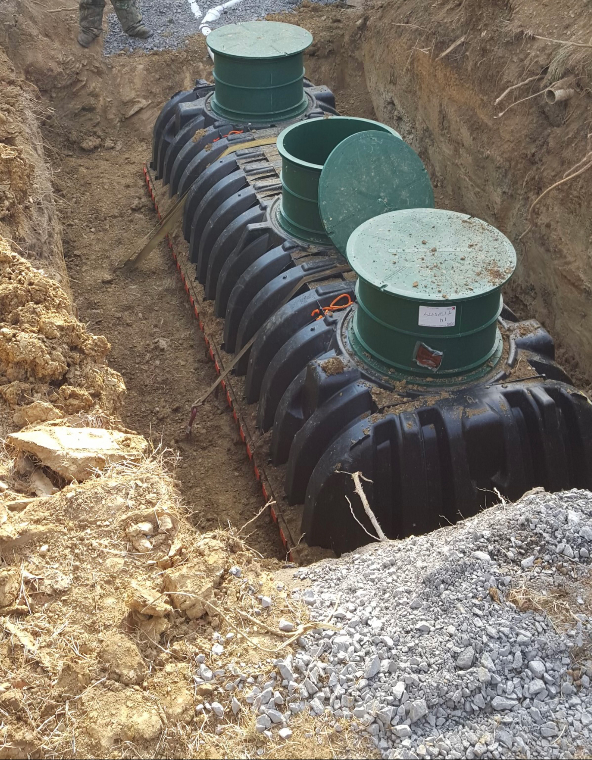 New septic tank lowered into place and ready to install