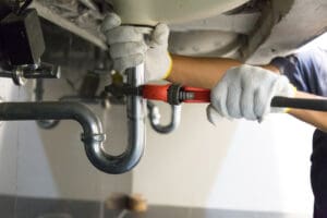 Plumbing fixing a pipe